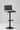 Bar stool with brown cushioned seat and backrest on a gray background